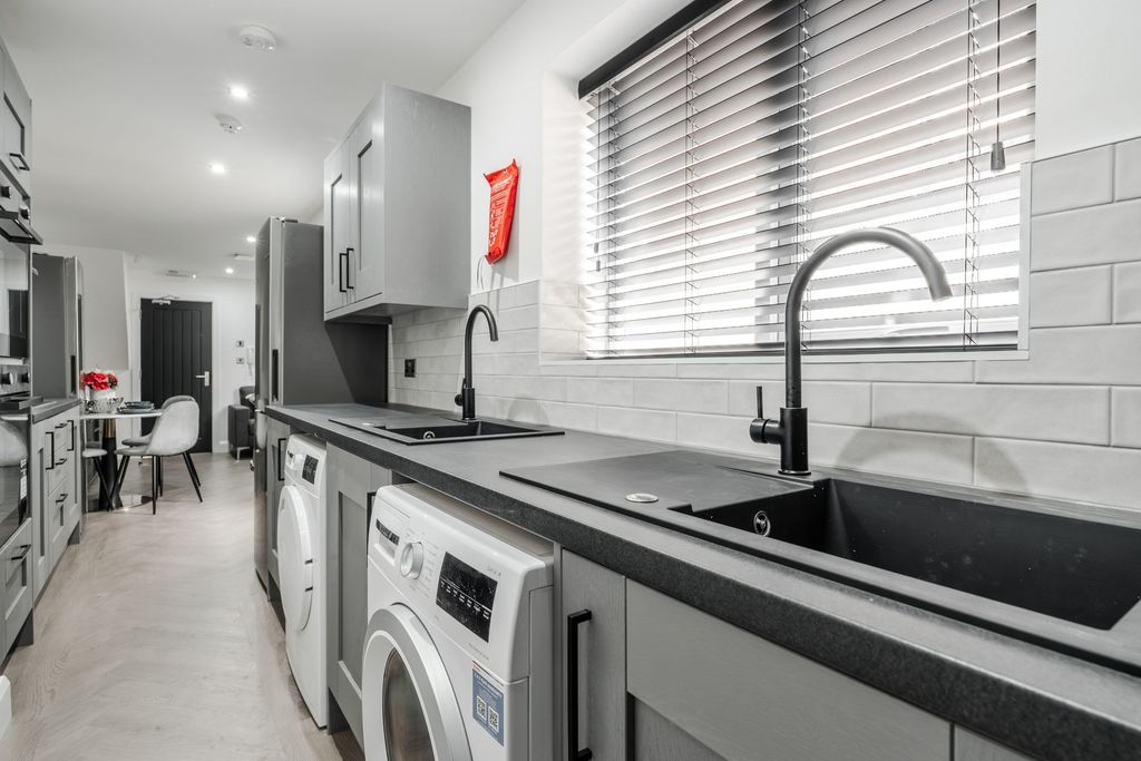Property photo 2 of 4 Modern, Bright Kitchen With Sleek Grey Cabinetry, ...