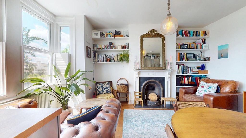 Property photo 3 of 14 A Bright And Inviting Living Room Featuring Large ...