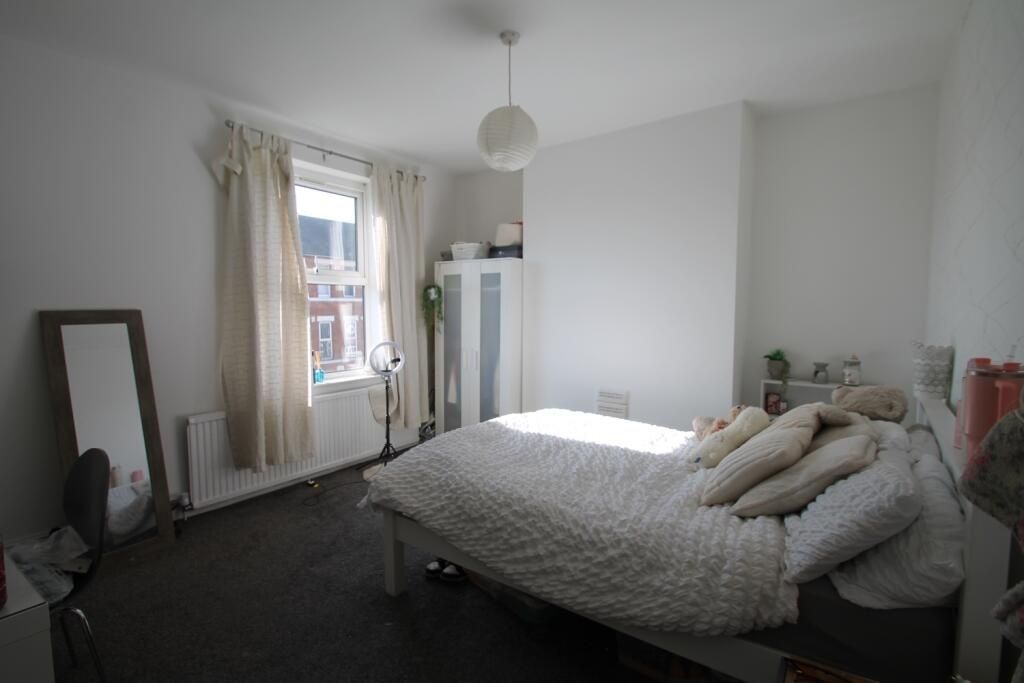Property photo 2 of 7 Bright And Airy Master Bedroom Featuring A Cozy Do...