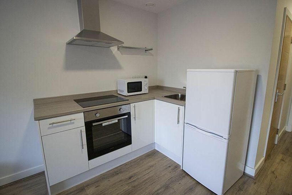 Property photo 2 of 3 Modern Kitchenette Featuring Sleek Cabinetry, Esse...
