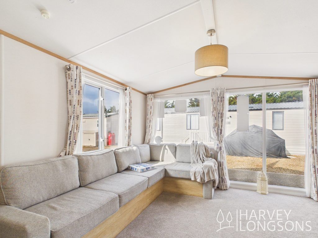 Property photo 3 of 15 Spacious Lounge With L-Shaped Sofa And Large Windows.