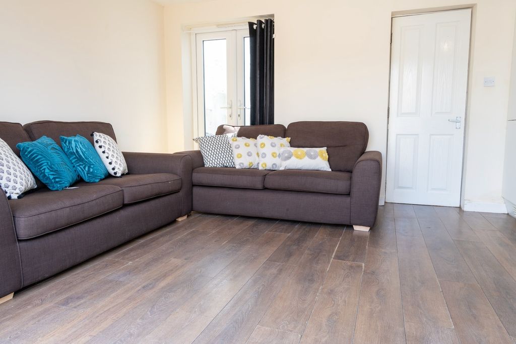 Property photo 3 of 11 Bright And Inviting Living Room Featuring Comforta...