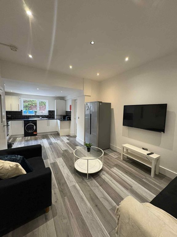 Property photo 2 of 13 Bright And Modern Living Room Featuring A Large Te...