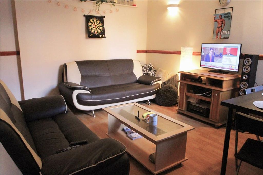 Property photo 3 of 14 This Inviting Living Room Features Stylish Seating...