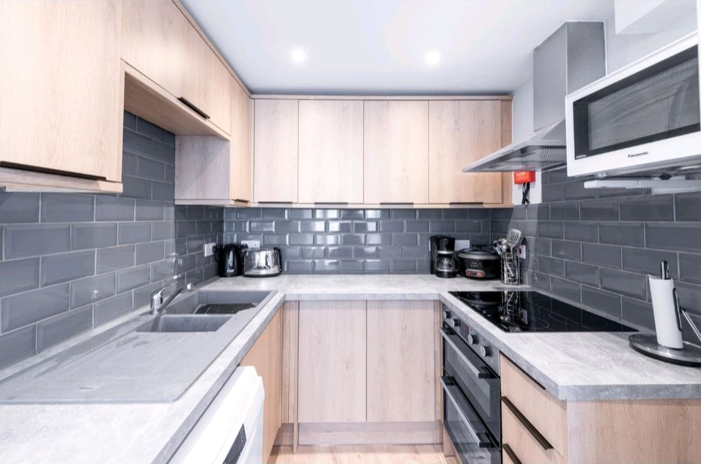 Property photo 3 of 5 Modern Kitchen With Sleek Tiling And Appliances...