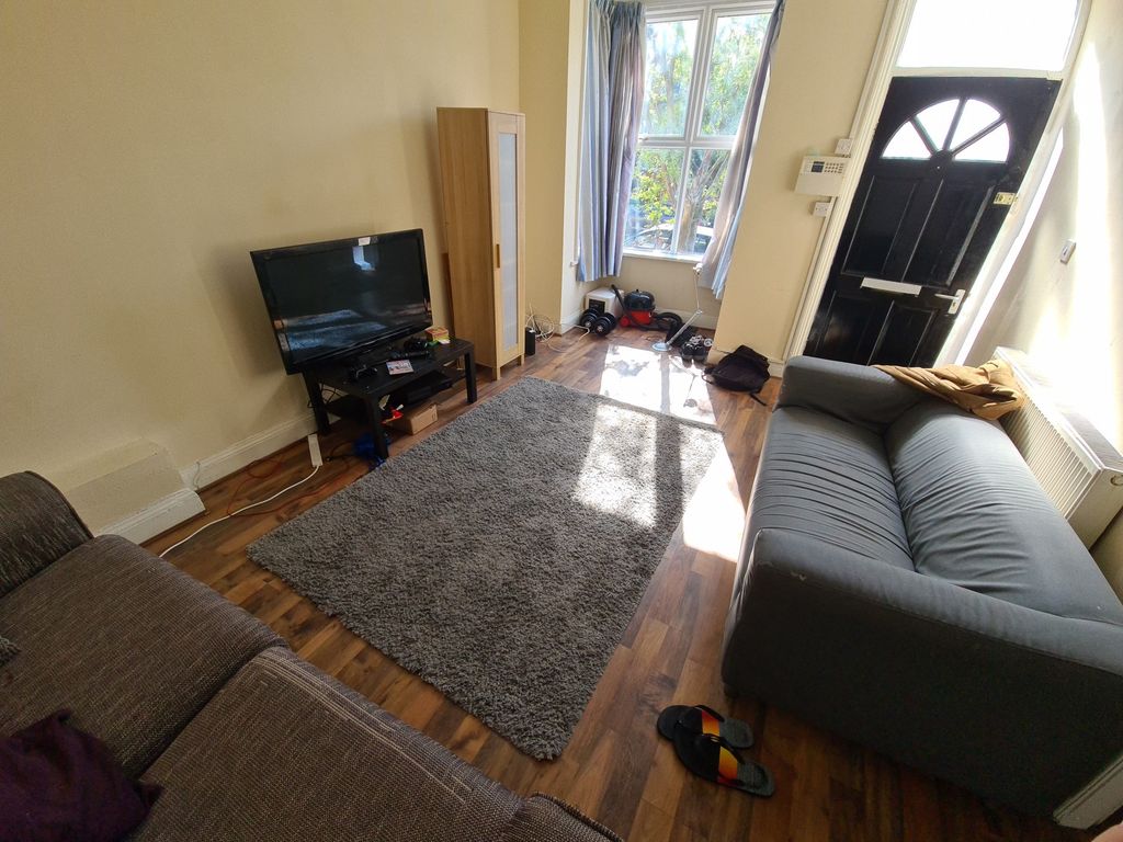 Property photo 3 of 13 A Well-Lit, Inviting Living Room Featuring Two Com...