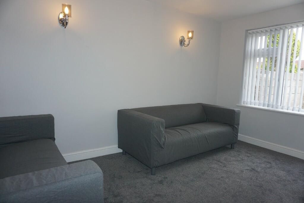 Property photo 3 of 8 A Bright And Inviting Living Room Featuring Modern...