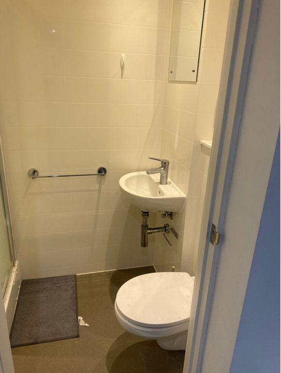 Property photo 1 of 5 A Tidy Bathroom Featuring Essential Amenities, Off...