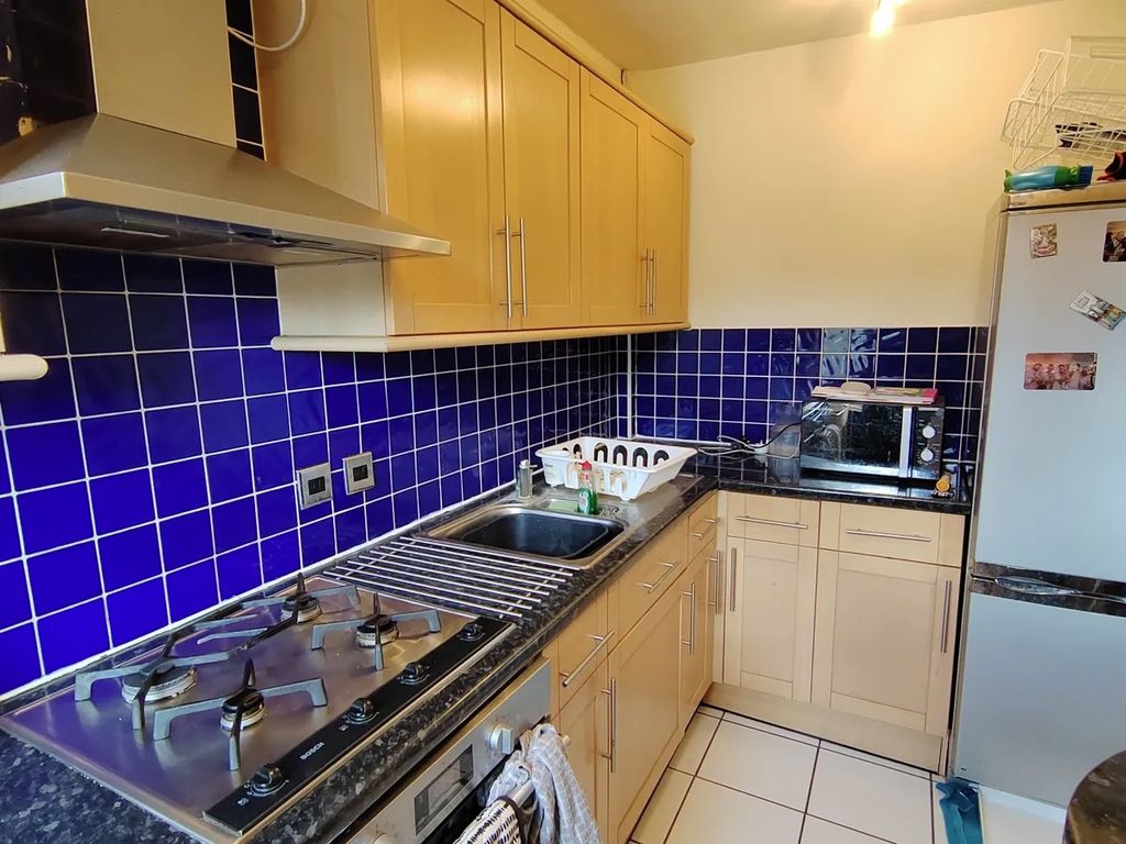 Property photo 2 of 11 Bright Kitchen With Vibrant Blue Tile Backsplash...