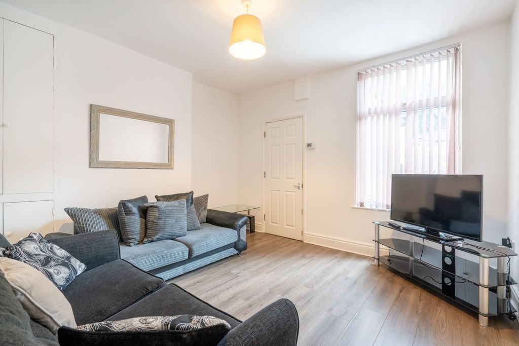 Property photo 2 of 10 Bright And Welcoming Living Room Featuring Two Com...