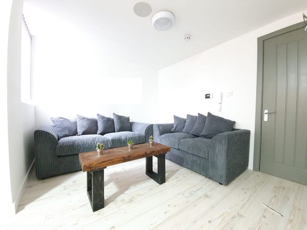 Property photo 3 of 4 A Bright And Inviting Living Room Featuring Comfor...