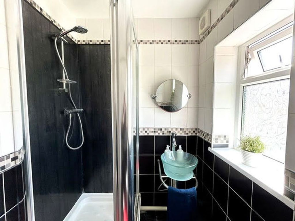 Property photo 1 of 6 A Modern Bathroom Featuring A Stylish Shower And A...
