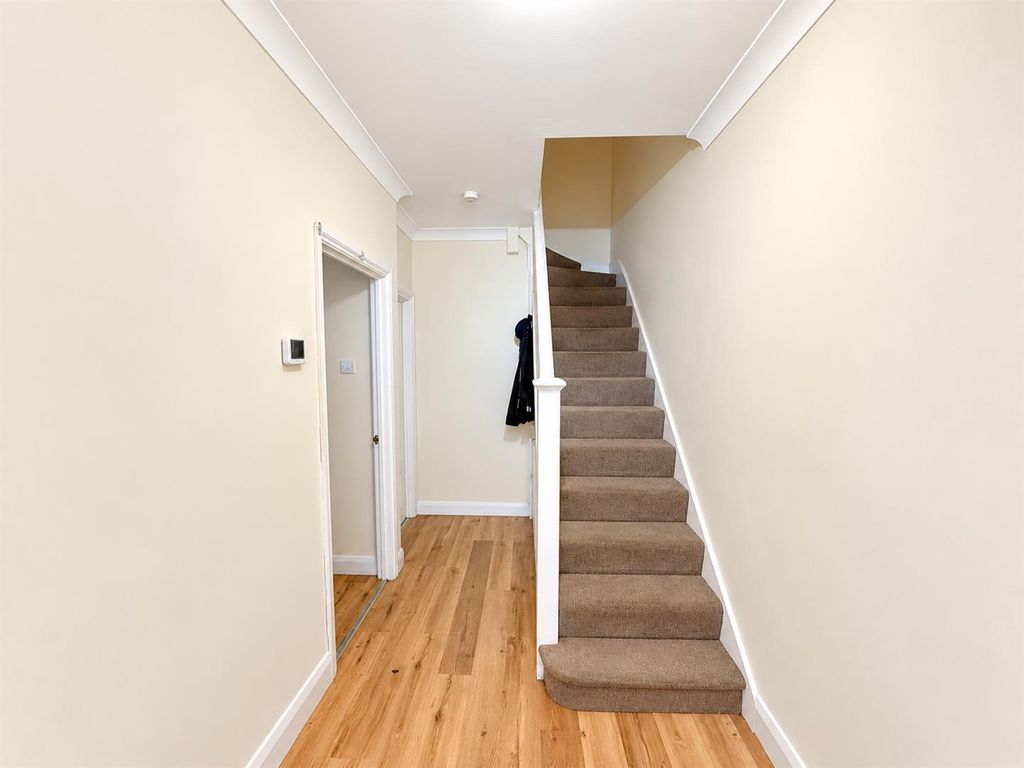 Property photo 2 of 11 Bright Minimalist Hallway With Staircase.Png