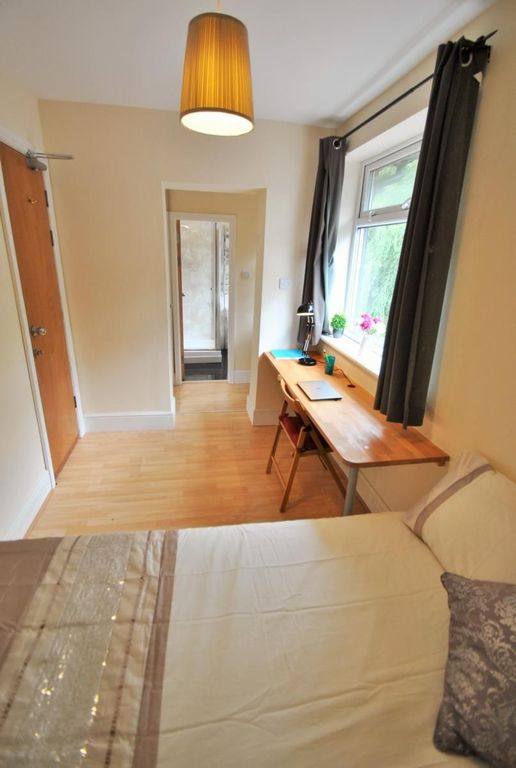 Property photo 3 of 15 A Cozy Single Bedroom Featuring A Neatly Made Bed,...