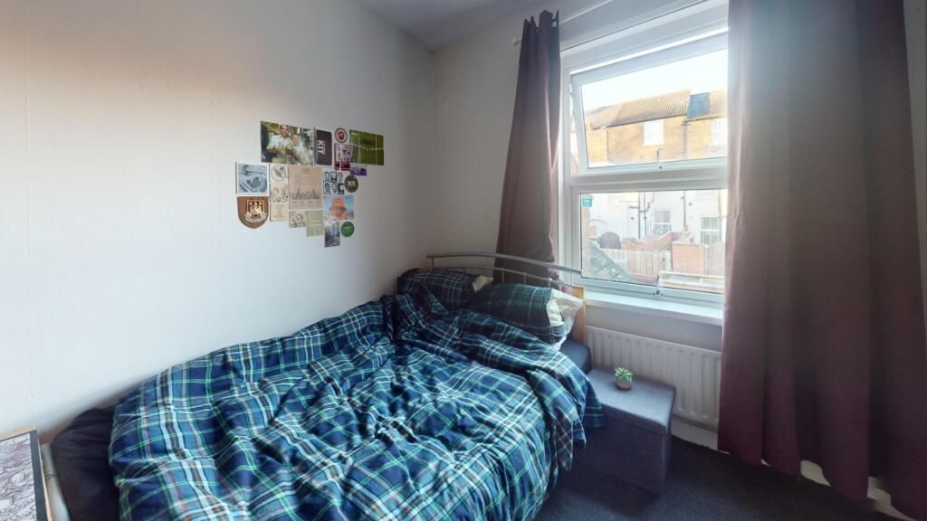 Property photo 2 of 14 Cozy Single Bedroom Featuring A Comfortable Bed Wi...