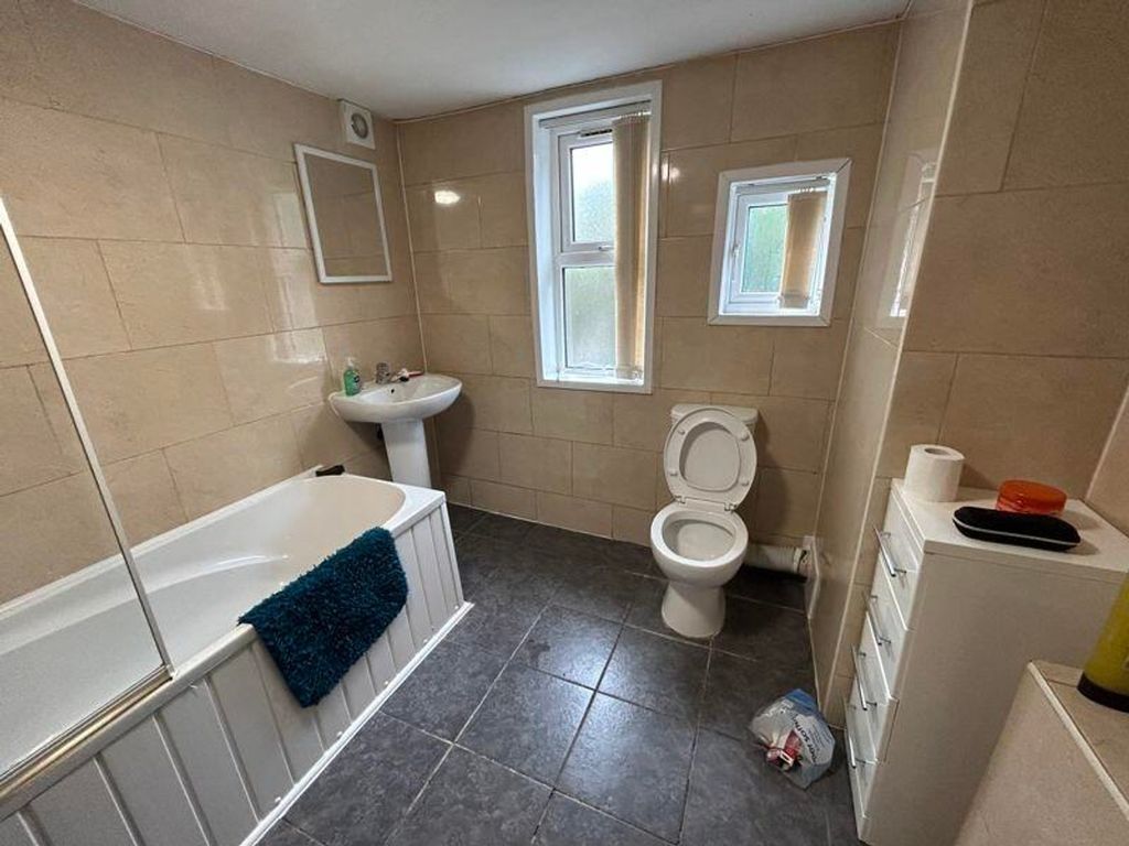 Property photo 2 of 5 A Spacious And Well-Lit Bathroom Featuring A Bath ...