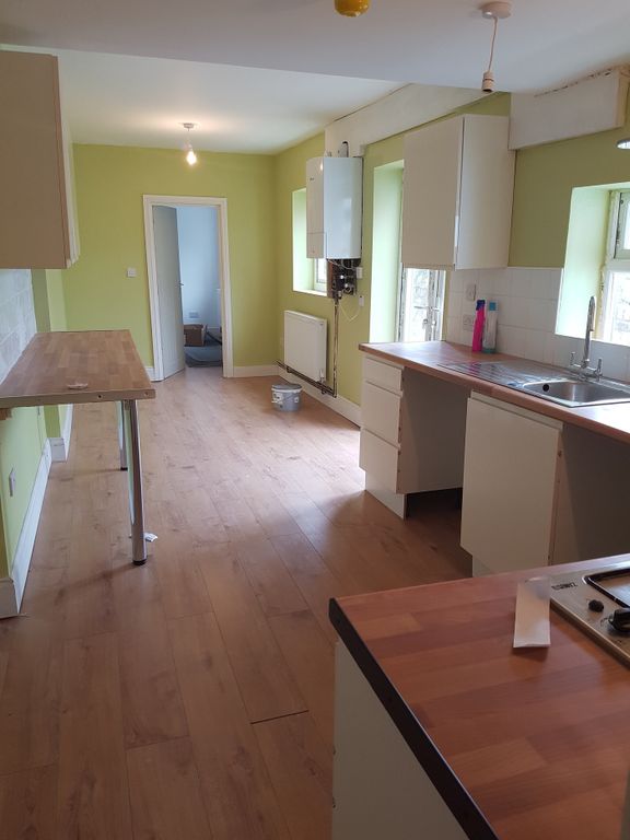 Property photo 2 of 4 A Spacious And Well-Lit Kitchen Featuring Modern c...