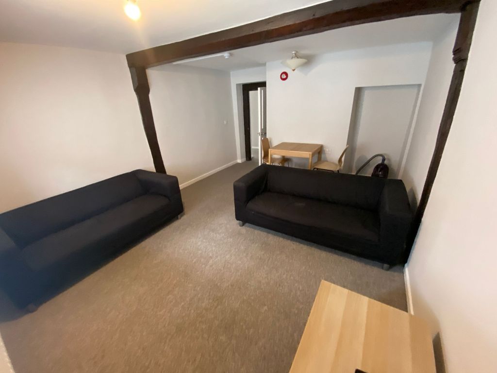 Property photo 3 of 10 A Cozy Living Room Featuring Two Black Sofas Facin...