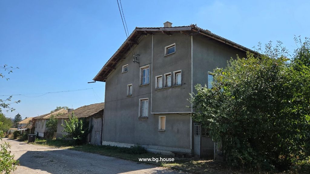 Property photo 1 of 97 A Large Three-Storey House With Several Windows And A Sloped Roof, Situated Next To A Dirt Road With Greenery Around.