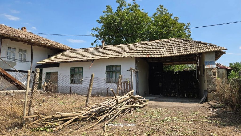 Property photo 2 of 75 Side View Showing Traditional Bulgarian House With Annexes, Tiled Roofs, Fenced Yard With Dry Branches And Sparse Vegetation Under A Clear Sky.