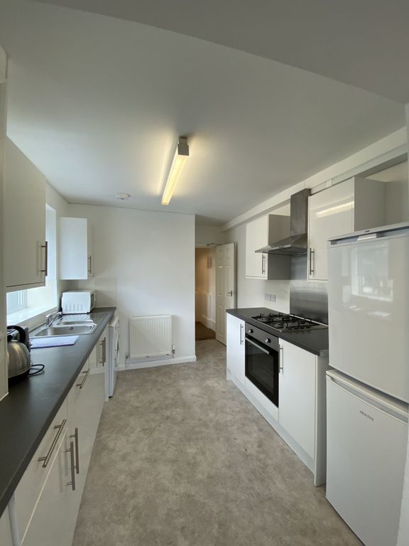 Property photo 1 of 9 A Bright, Clean Kitchen Featuring Modern White Cab...