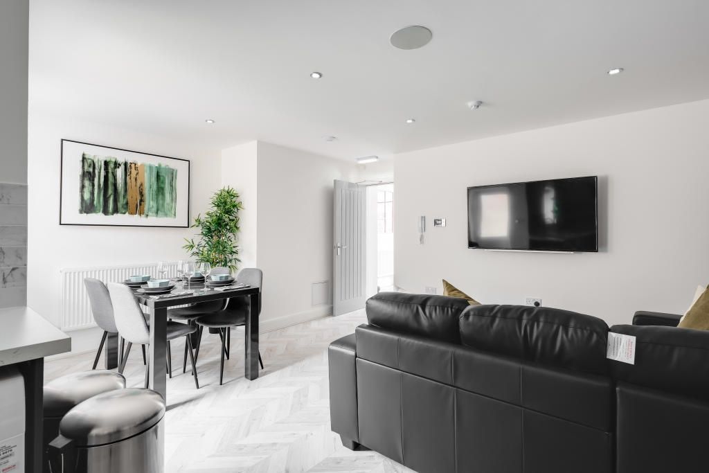 Property photo 3 of 12 Modern And Bright Living Room Featuring Contempora...