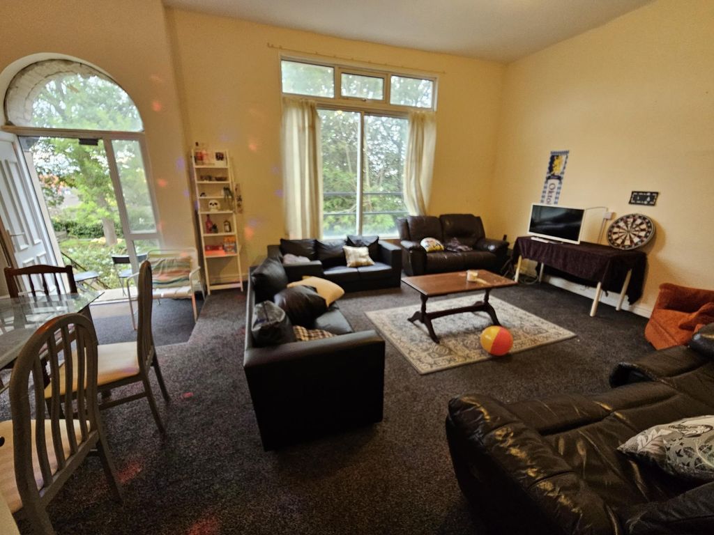 Property photo 2 of 29 A Spacious And Inviting Living Room Featuring Comf...