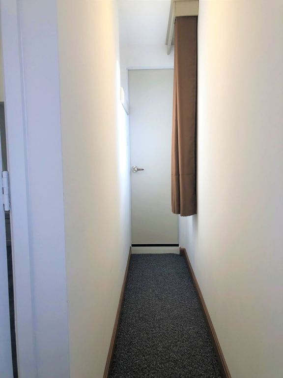 Property photo 1 of 12 A Clean, Narrow Hallway With Neutral Walls And A c...