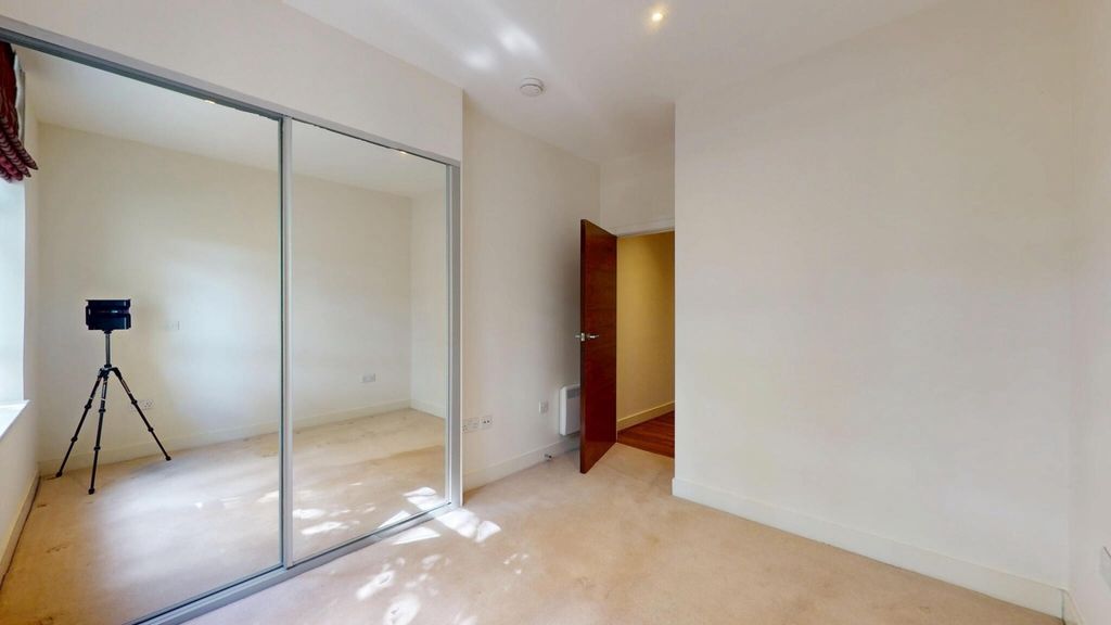 Property photo 1 of 14 A Bright And Clean Bedroom Featuring A Large Mirro...