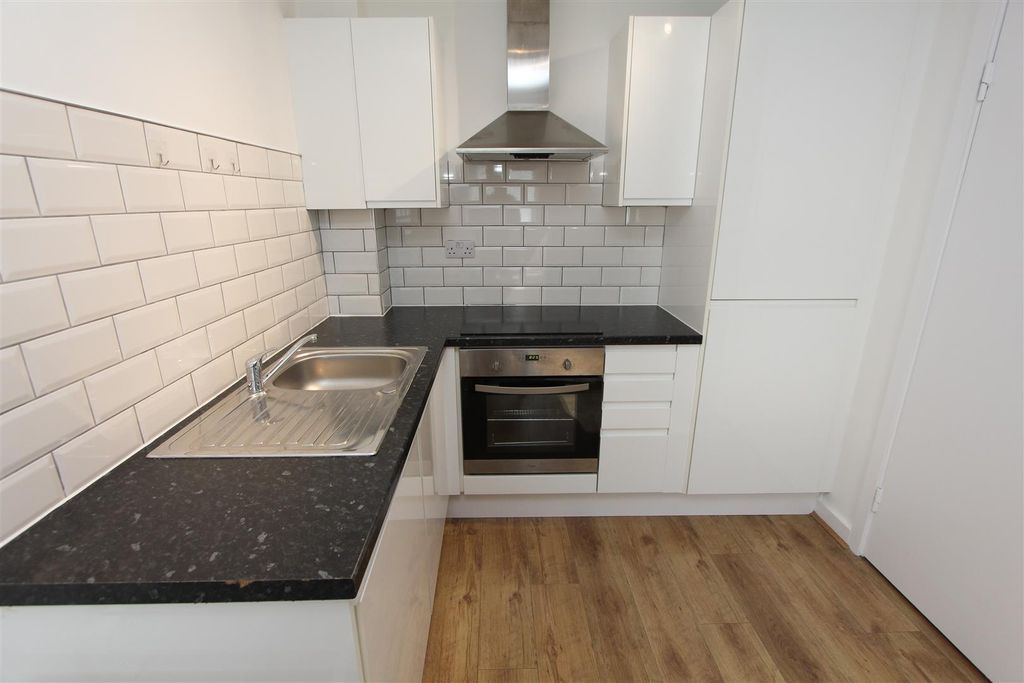 Property photo 3 of 9 Modern Kitchen With Sleek White Cabinetry...