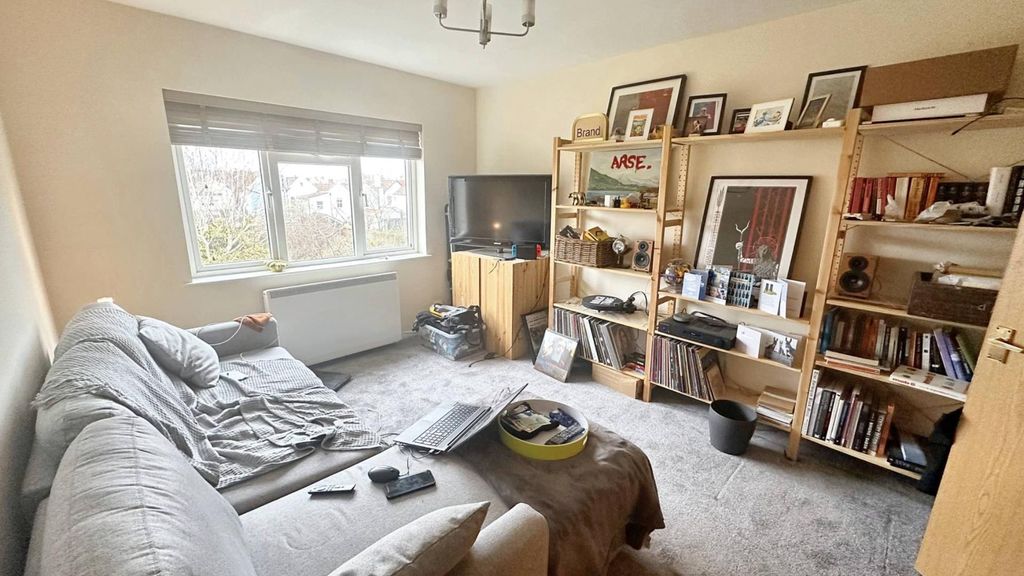 Property photo 2 of 5 Bright Living Room With Ample Shelving And Sofa...