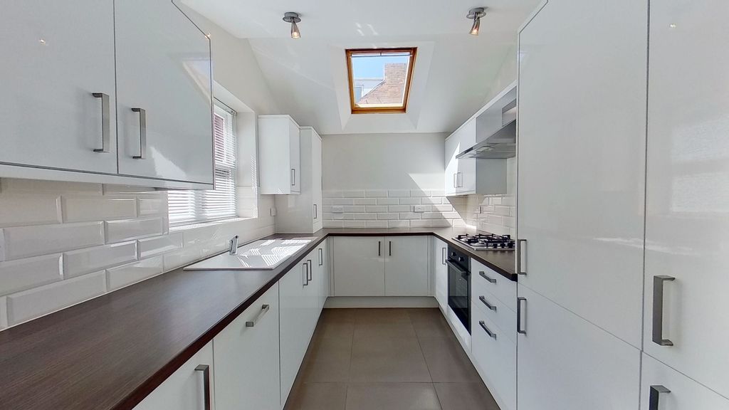 Property photo 3 of 10 Contemporary Galley Kitchen With Glossy White Cabi...