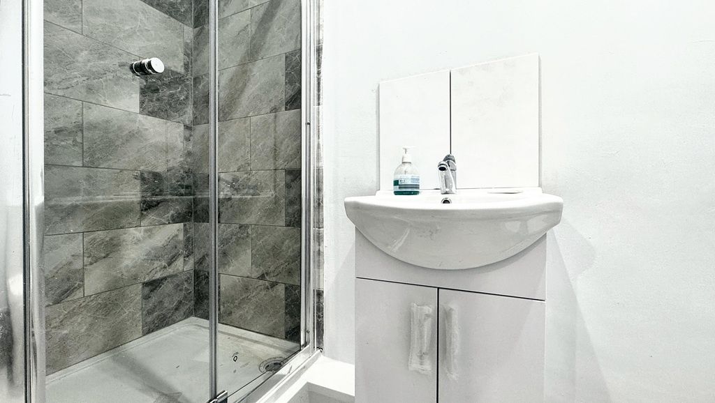Property photo 3 of 10 Bright, Modern Bathroom With A Glass-Enclosed Show...