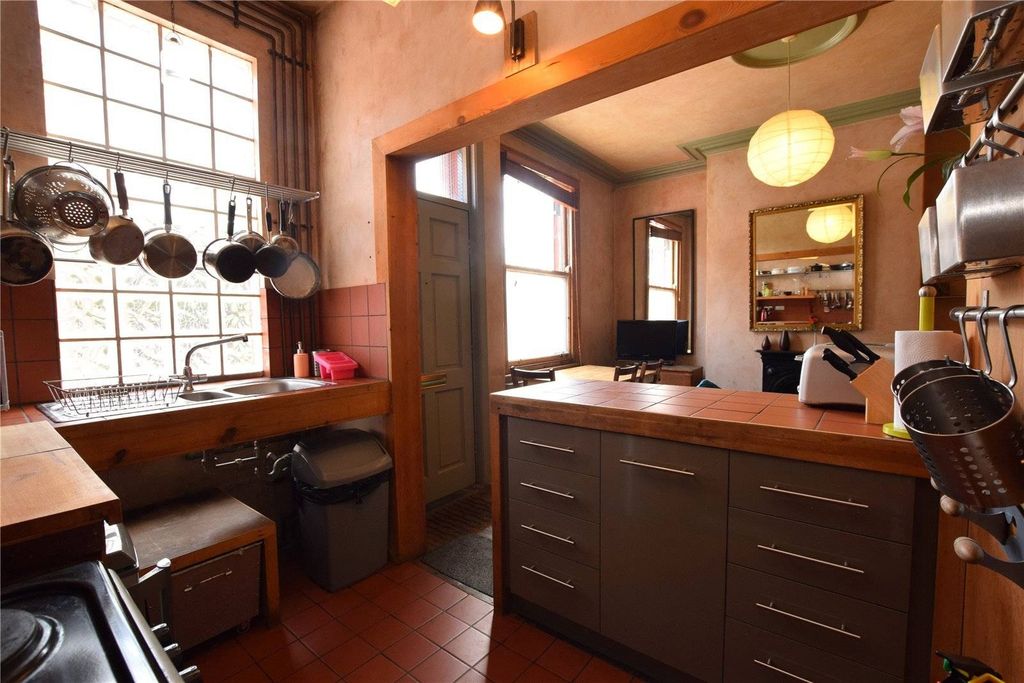 Property photo 3 of 9 A Charming Kitchen Featuring Warm Wooden Cabinetry...