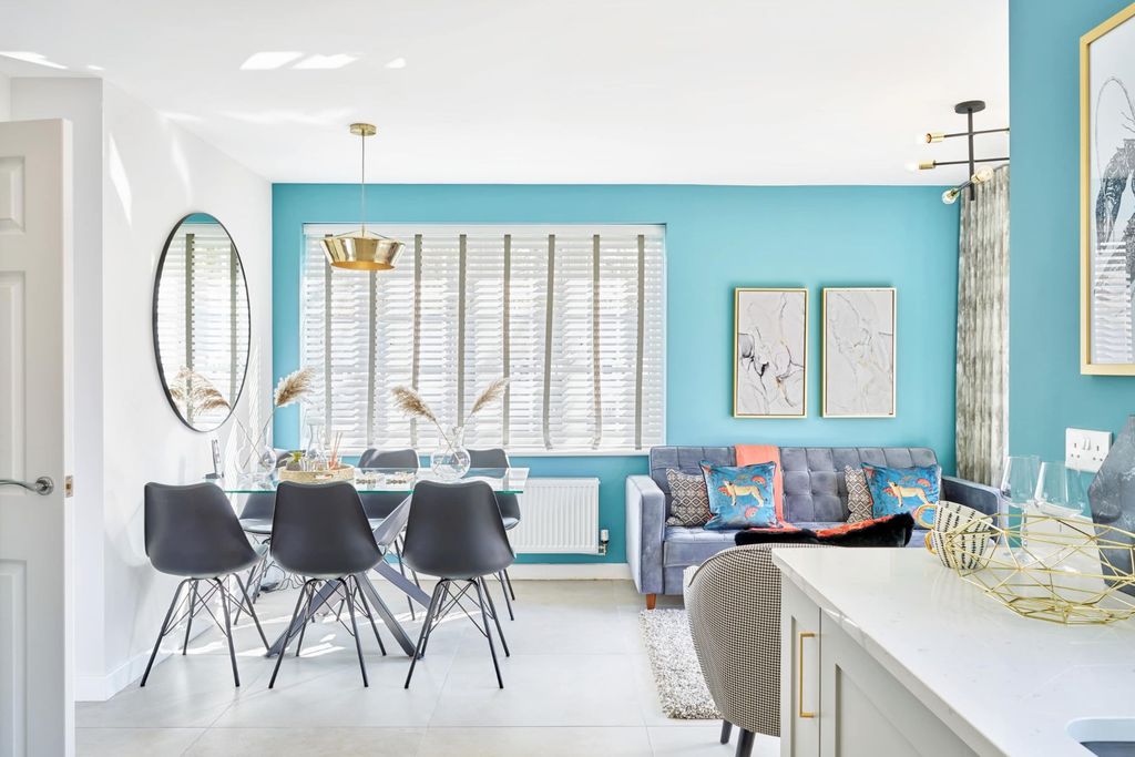 Property photo 3 of 10 A Modern Dining And Living Area Features A Glass-Top Dining Table With Black Chairs In The Foregroun