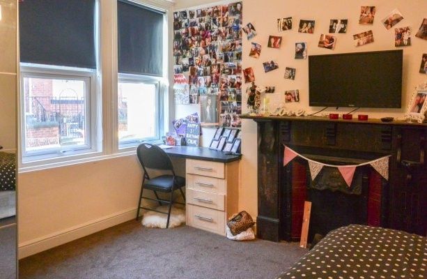 Property photo 3 of 9 A Well-Lit Bedroom Featuring A Desk, A Window With...