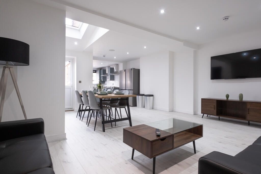 Property photo 2 of 15 Bright And Modern Living Room Featuring Sleek Whit...