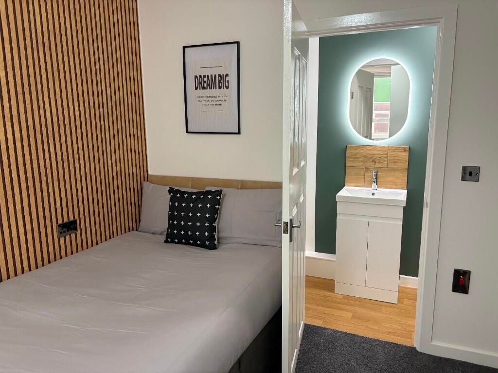 Property photo 1 of 15 A Modern And Cozy Master Bedroom Featuring A Comfo...