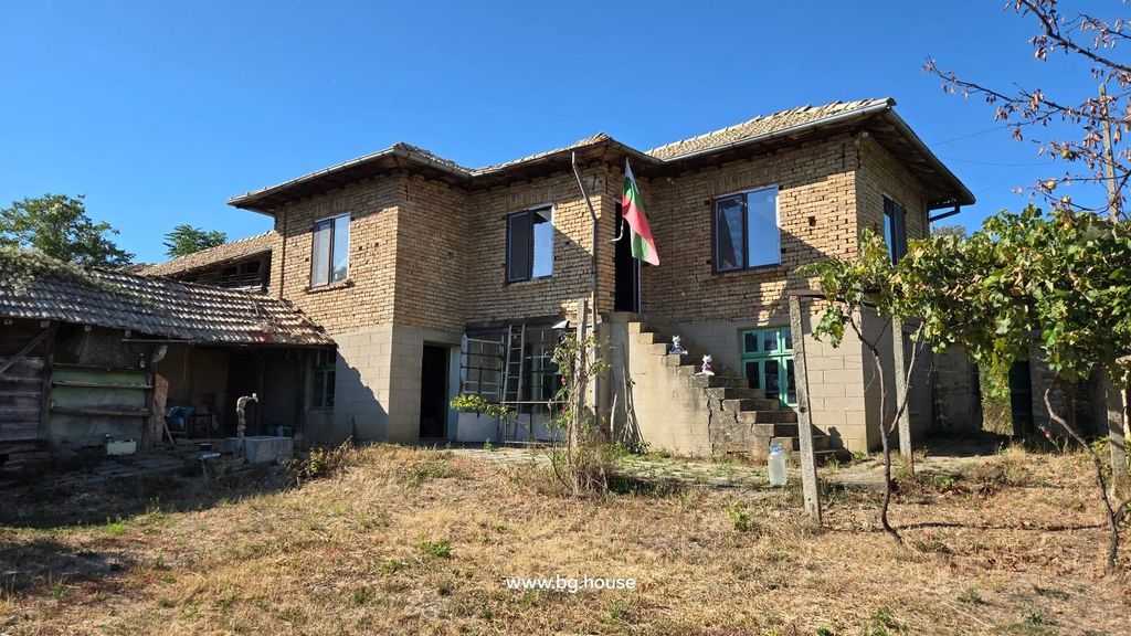 Property photo 1 of 90 Two-Story Brick House With Tiled Roof And External Staircase, Surrounded By Dry Grass And Some Trees Under Clear Blue Sky