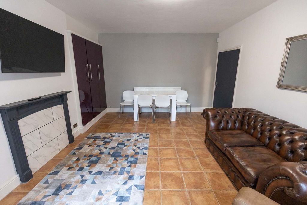 Property photo 3 of 5 Spacious And Contemporary Living Room Featuring Co...