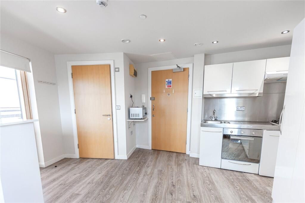 Property photo 2 of 4 Bright And Modern Kitchen Area Featuring Light Woo...