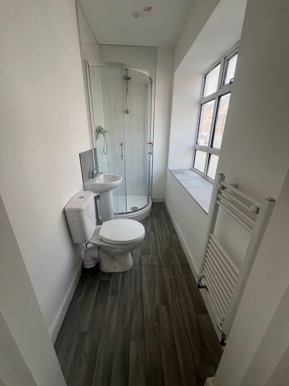 Property photo 2 of 8 Bright And Tidy Bathroom Featuring A Corner Shower...