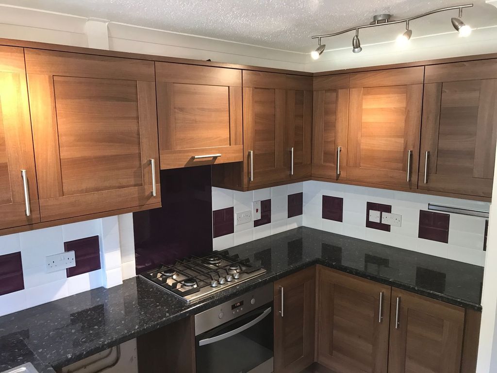 Property photo 3 of 5 A Modern Kitchen Featuring Wooden Cabinets, A Slee...