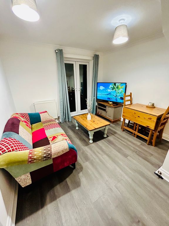 Property photo 2 of 11 A Cozy Living Room With A Colorful Sofa, Ample Nat...