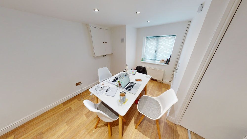 Property photo 3 of 8 Bright And Modern Living Room Featuring Ample Natu...