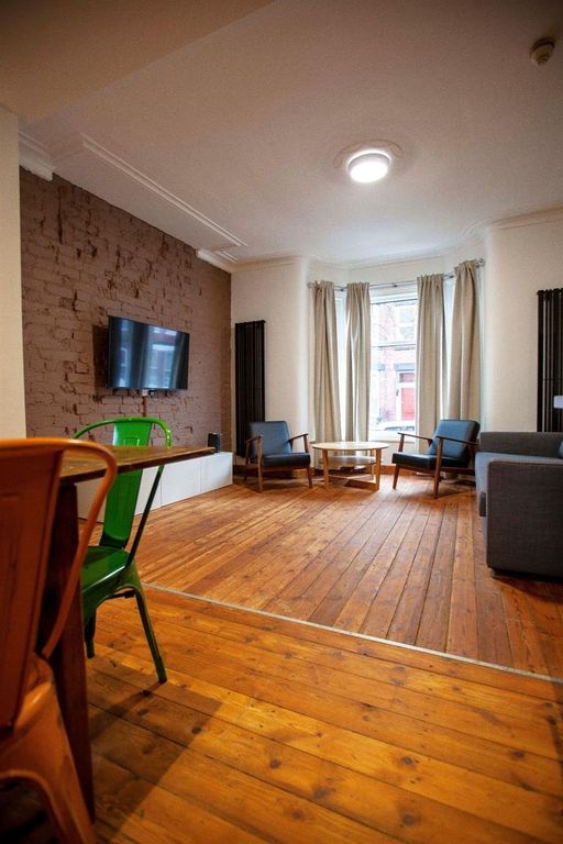 Property photo 2 of 13 Spacious Living Area With Warm Wood Flooring...