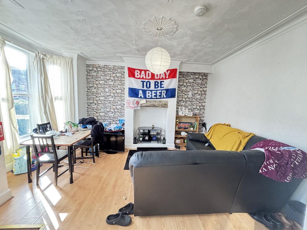 Property photo 1 of 18 Bright And Stylish Living Room Featuring A Comfort...