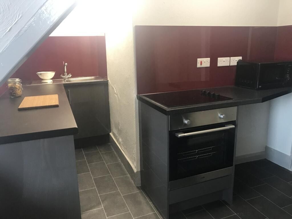 Property photo 3 of 4 Modern Kitchen With Sleek Dark Units And Stove...