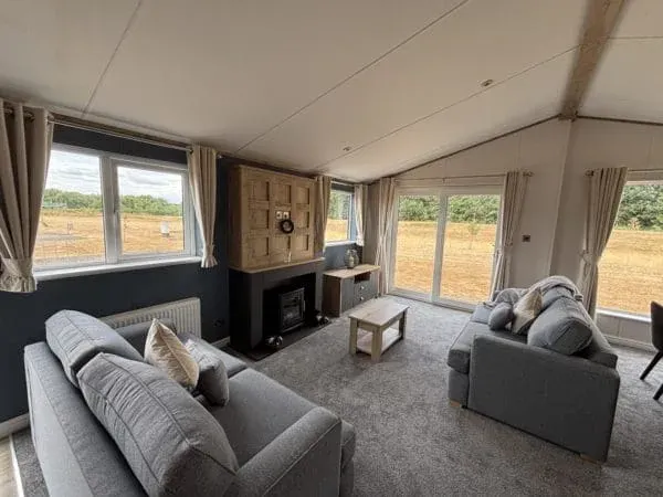Property photo 3 of 16 Comfortable Lounge With Grey Sofas, Fireplace And Large Windows