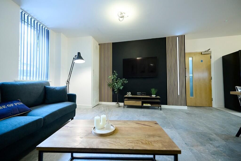 Property photo 3 of 12 A Modern Living Room Featuring A Stylish Dark Blue...